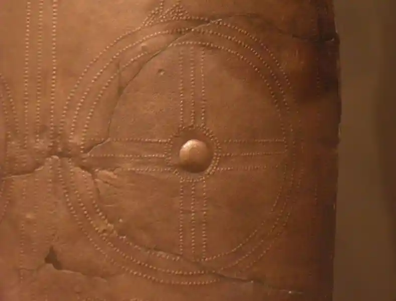 Dots forming a cross inside a circle